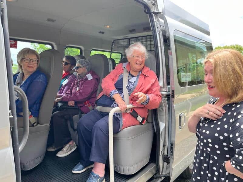 Amanda helping guests settle into the van